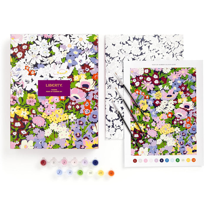 Two floral patterned notebooks with Liberty branding on a white background