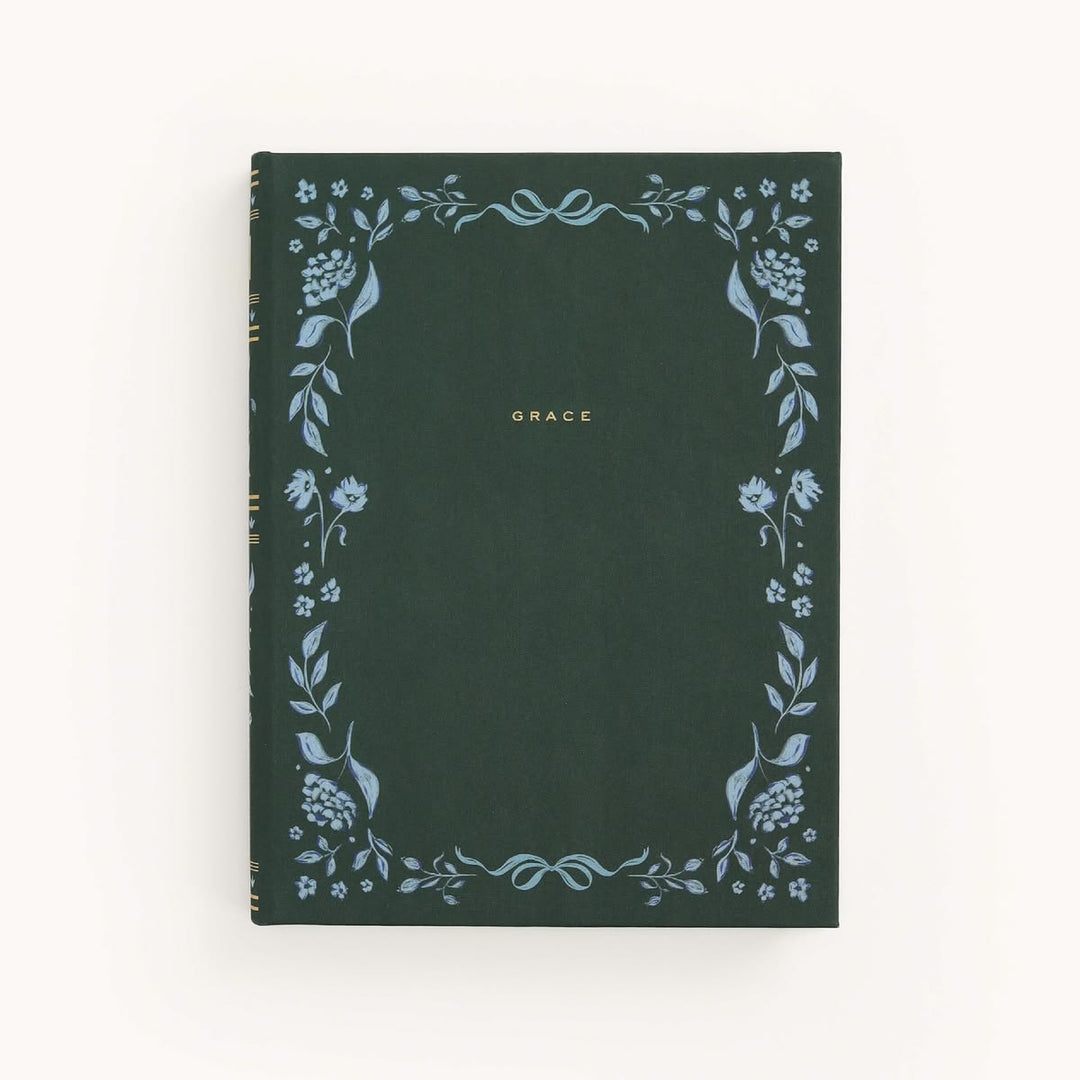 Dark green notebook with floral designs and 'GRACE' text on a white background
