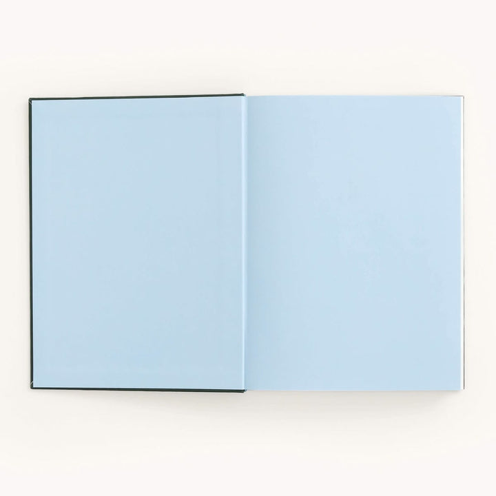 Open book with light blue pages on a white background