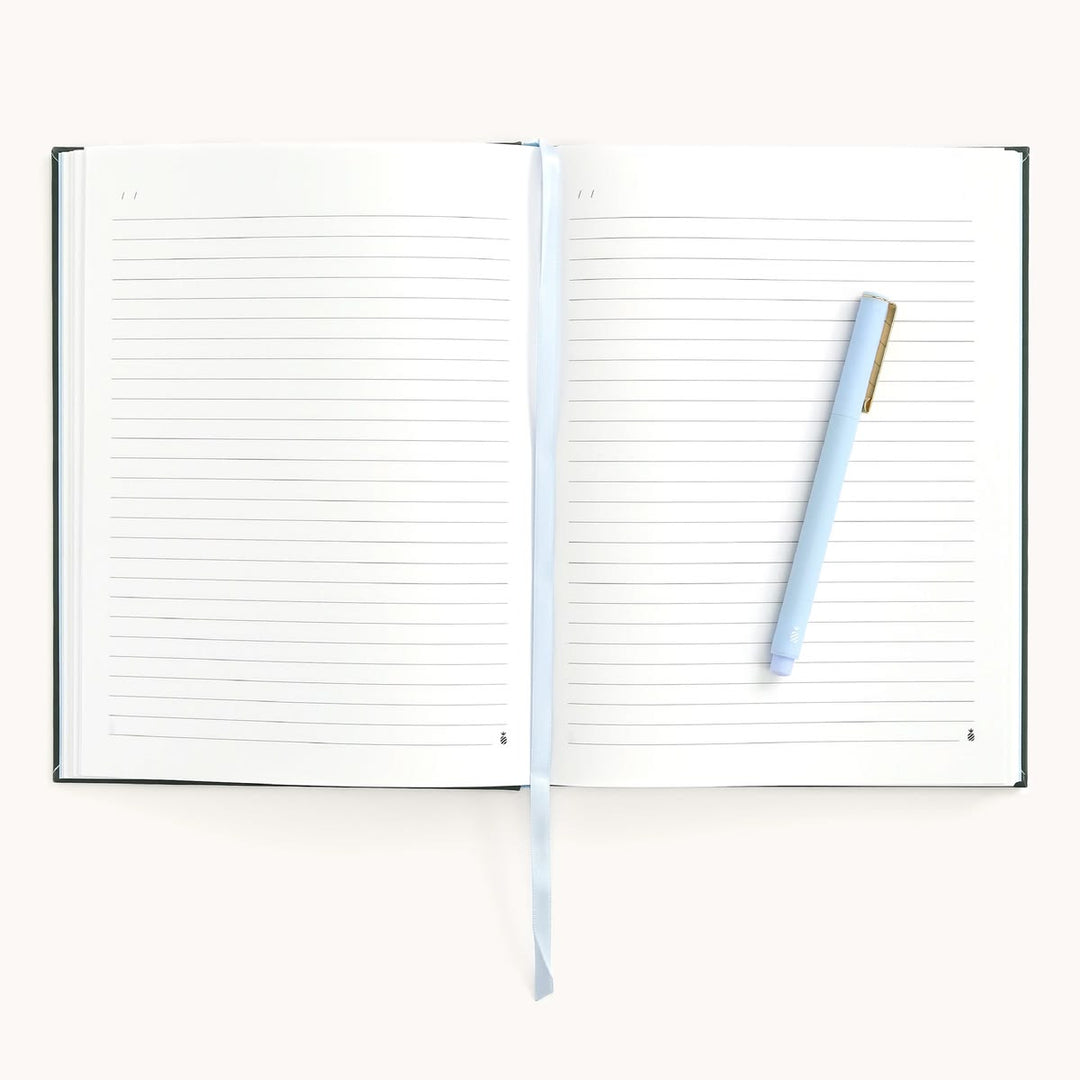 Open notebook with lined pages and a pen on a white background
