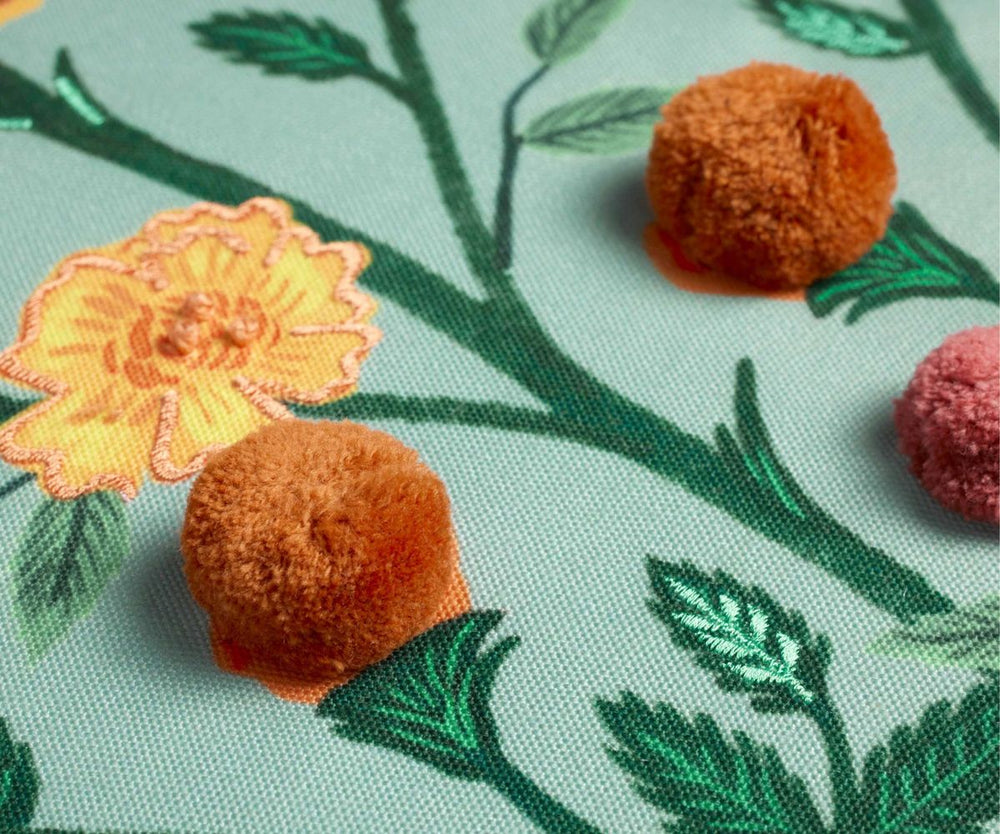Close-up of embroidered flowers and leaves on fabric