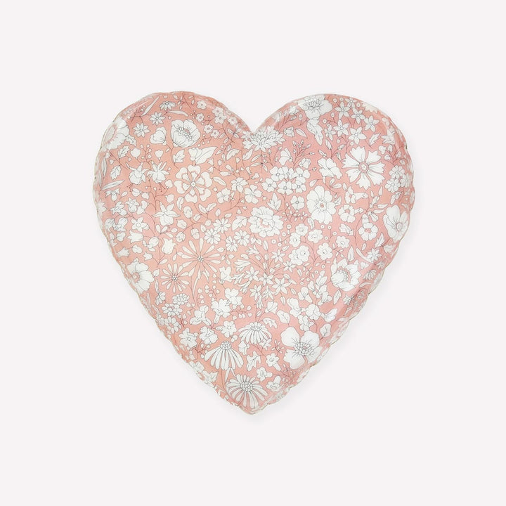A heart-shaped decorative pillow featuring a delicate white and gray floral pattern on a soft pink background, shown against a plain off-white backdrop.