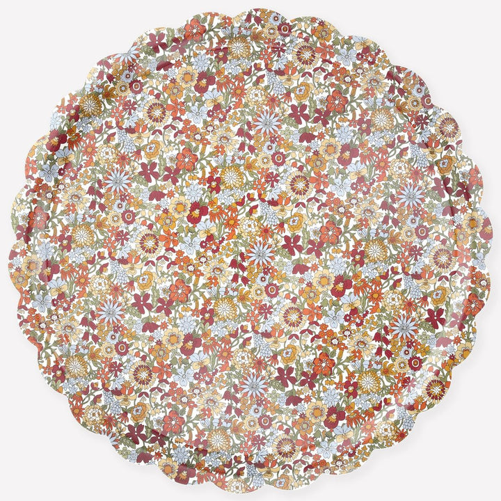 Round floral patterned placemat with multicolor flowers on a white background
