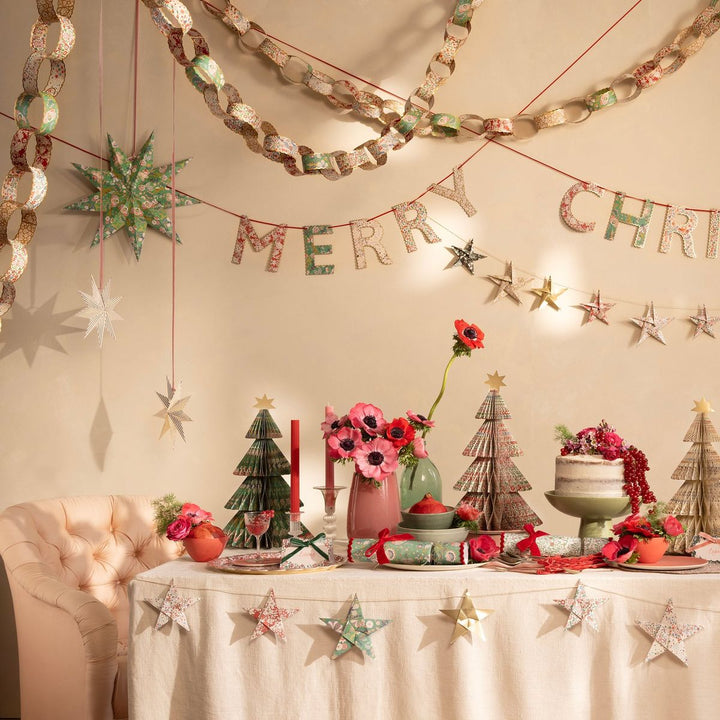 Decorated Christmas table with festive decorations and a 'Merry Christmas' banner.