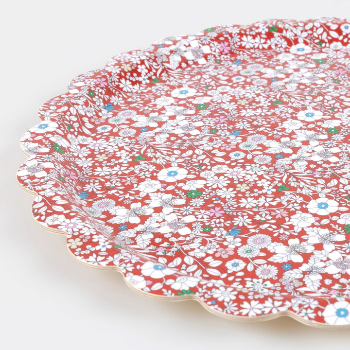 Floral-patterned paper plates on a white background
