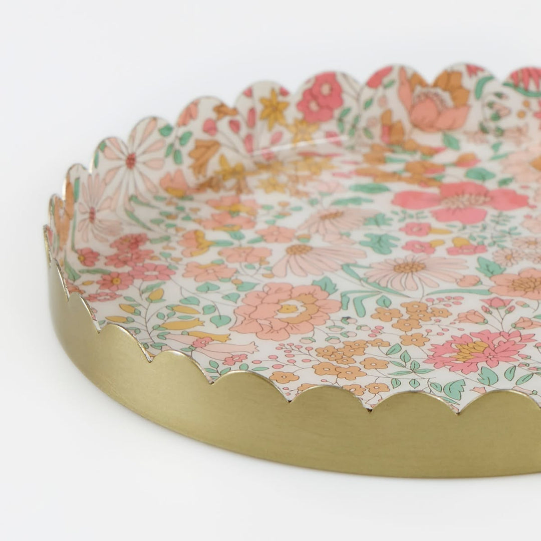 Decorative tray with floral pattern and scalloped edge on a white background