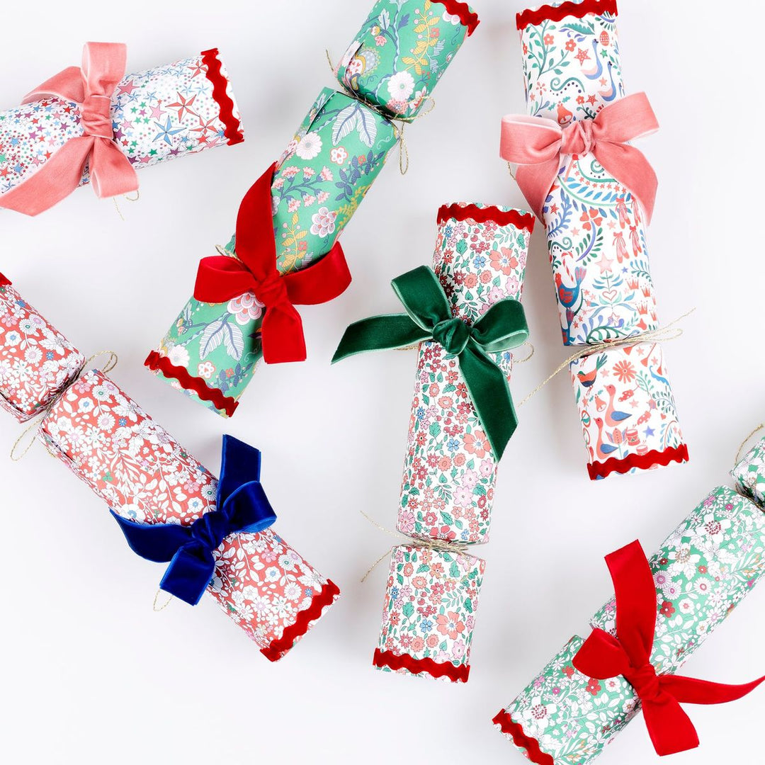 Decorative Christmas crackers with colorful bows on a white background