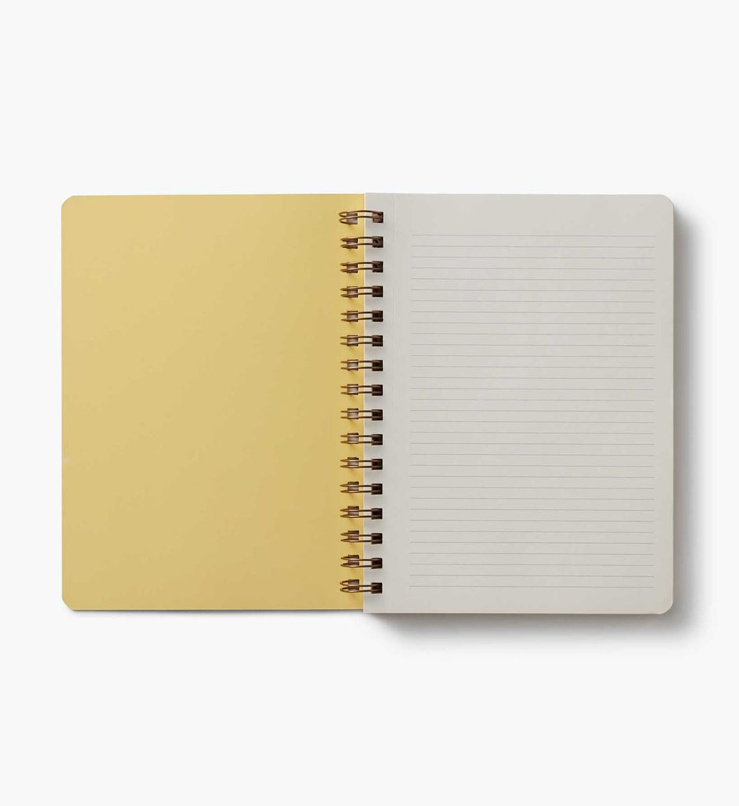 Open notebook with beige cover and white lined pages on a white background