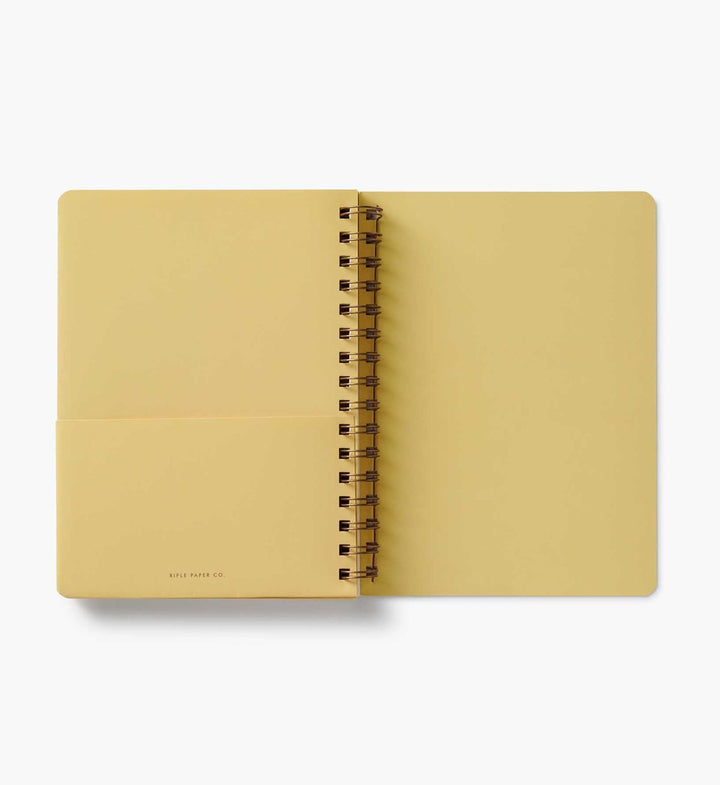 Yellow notebook with a spiral binding on a white background