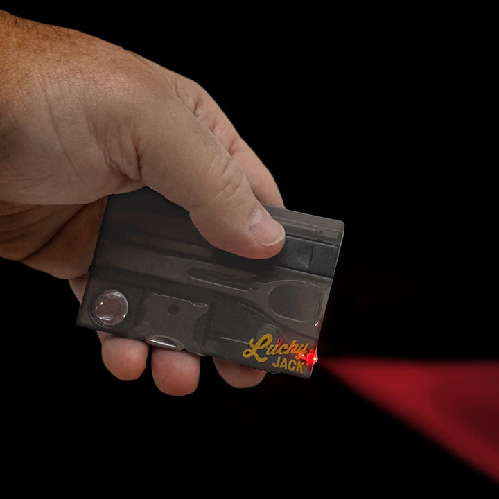 Hand holding a small electronic device labeled 'Lucky Jack' against a black background