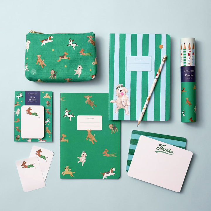 Collection of stationery items with green and animal pattern on a light blue background