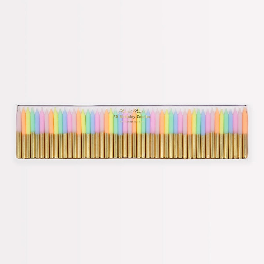 A set of 24 pastel-colored taper candles in a clear plastic case with gold metal wicks, shown against a plain white background.