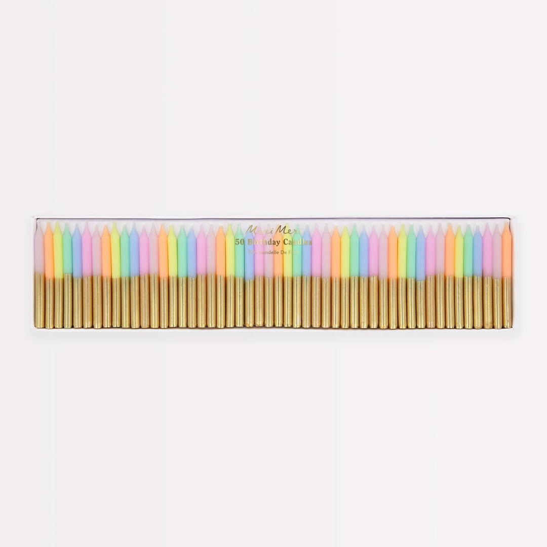 A set of 24 pastel-colored taper candles in a clear plastic case with gold metal wicks, shown against a plain white background.