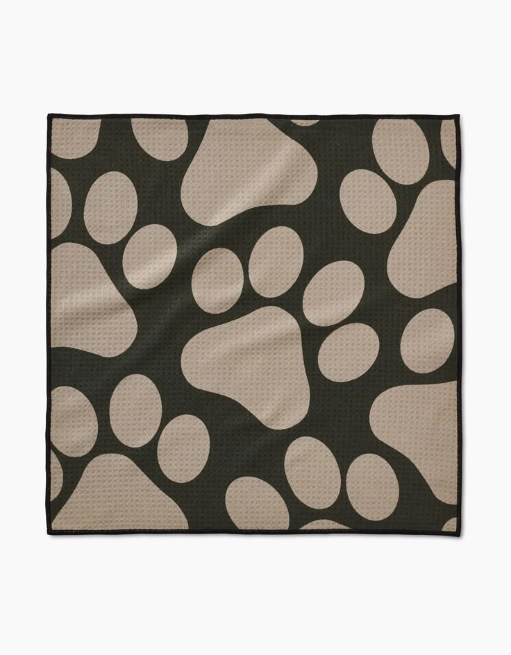 Black towel with beige paw print pattern on a white background