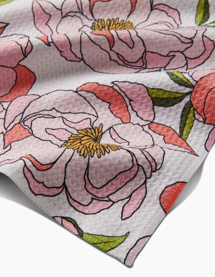 Floral patterned fabric with pink and red flowers on a white background