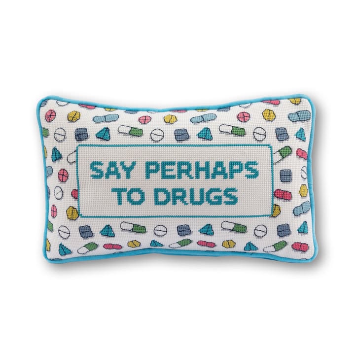 Decorative pillow with pill pattern and text 'Say Perhaps to Drugs' on a white background
