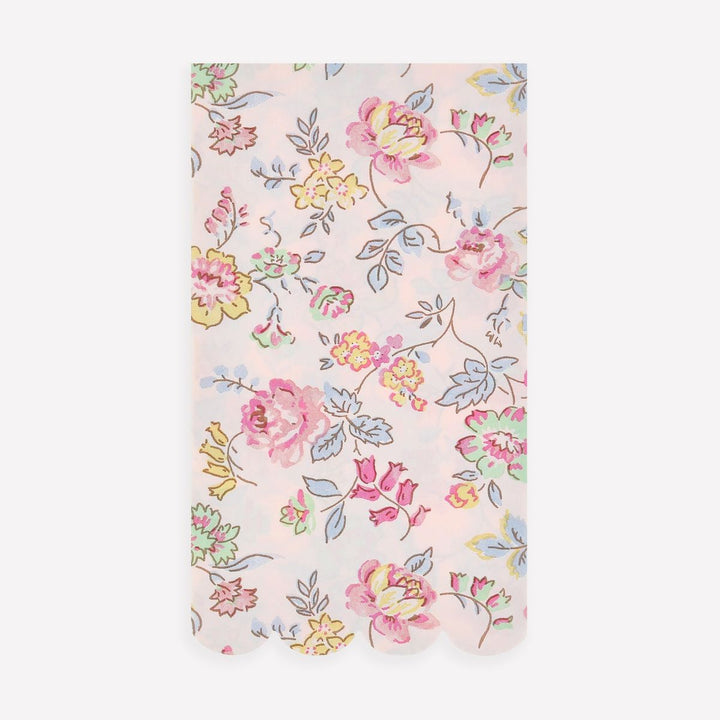 Floral patterned fabric with pink, yellow, and blue flowers on a light pink background