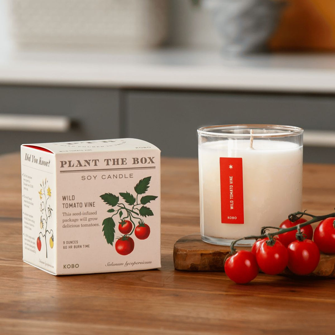 Kobo Plant the Box soy candle with packaging and tomatoes on a wooden surface