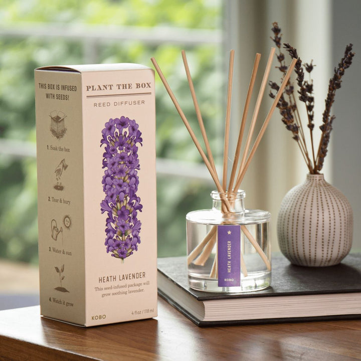 Reed diffuser set with packaging and lavender plant on a table
