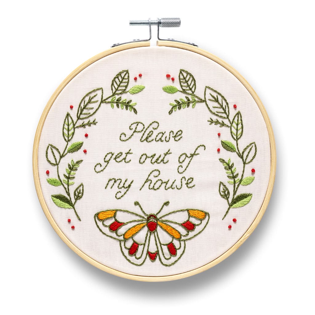 Embroidery hoop with floral design and butterfly, featuring text 'Please get out of my house'.