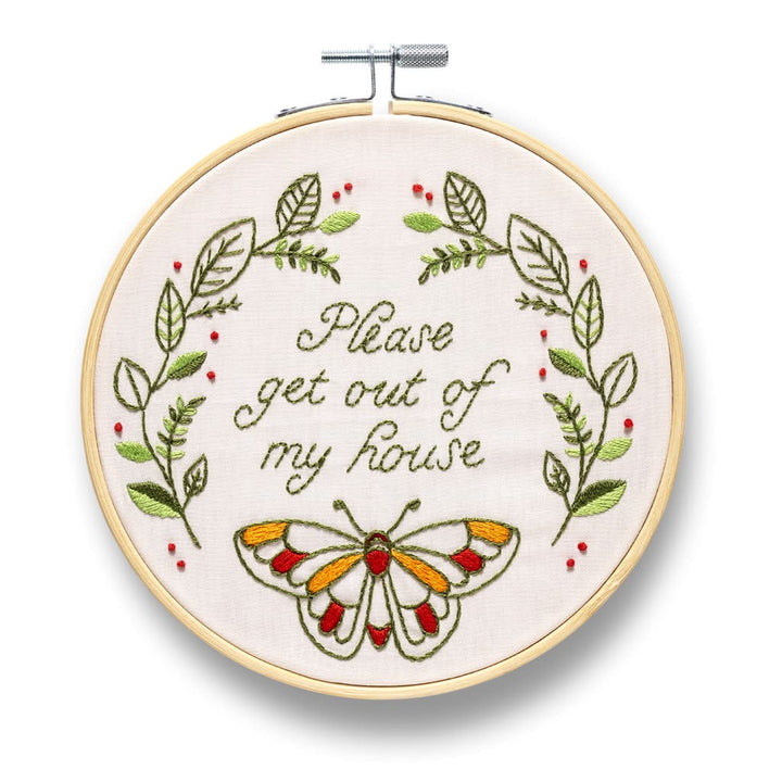 Embroidery hoop with floral design and butterfly, featuring text 'Please get out of my house'.