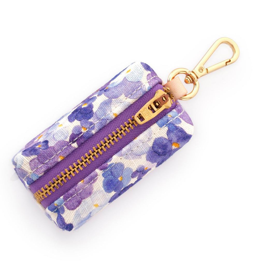 Floral-patterned keychain pouch with a gold zipper and clip on a white background