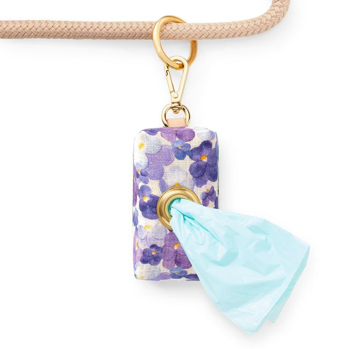 Decorative keychain with floral design and turquoise tassel on a white background