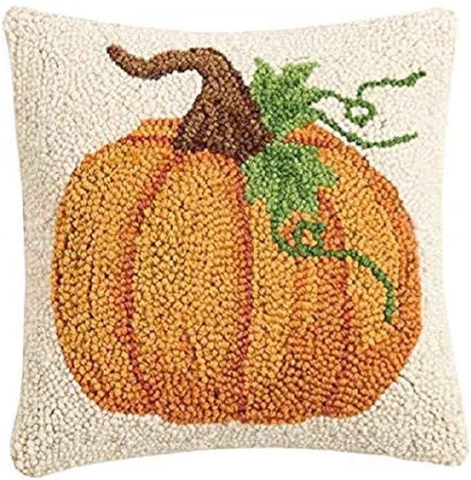 Pumpkin-themed decorative pillow with a textured surface on a white background