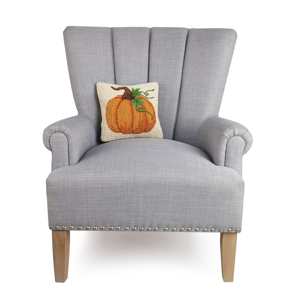 Gray armchair with a pumpkin pillow on a white background