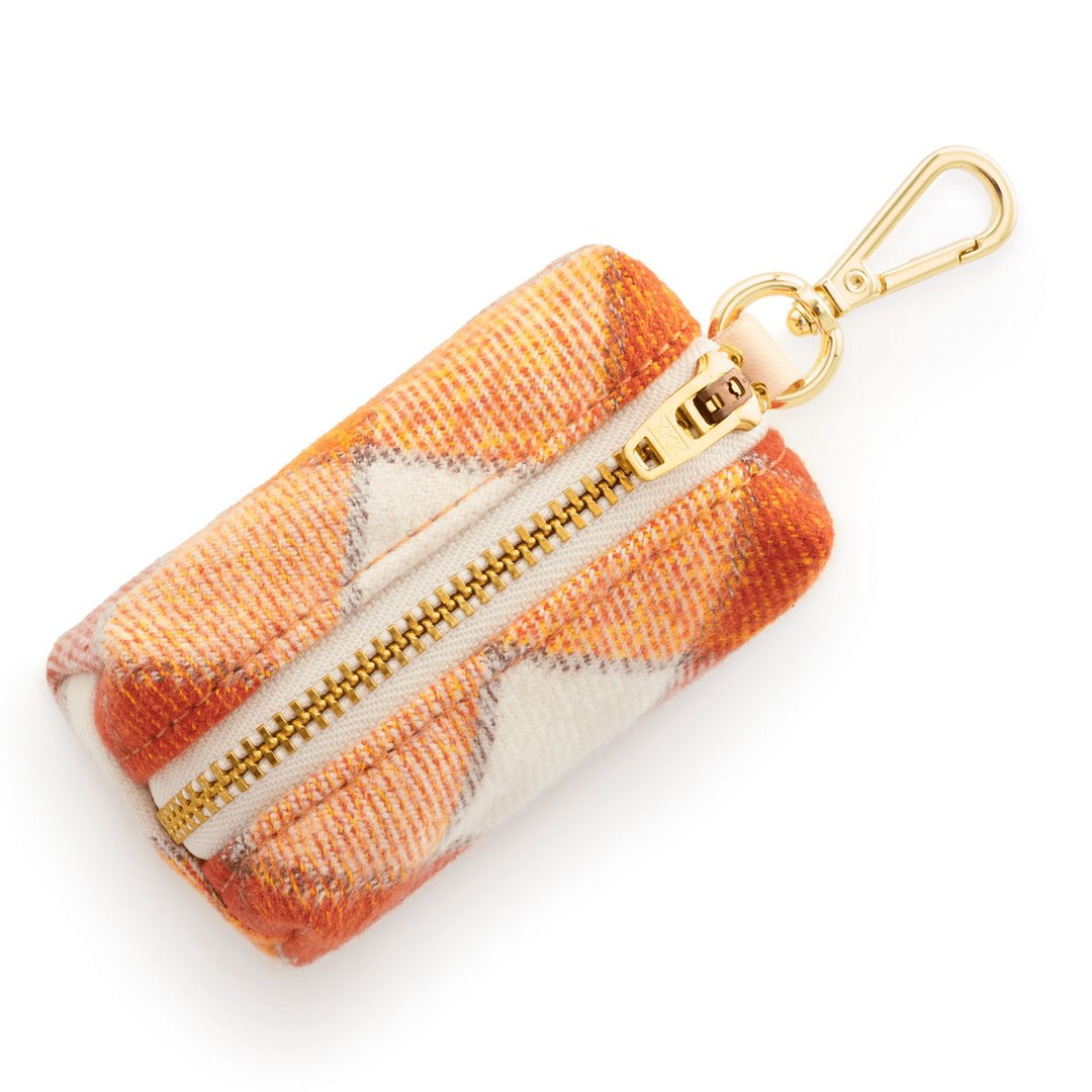 Plaid patterned pouch with gold zipper and keychain on a white background