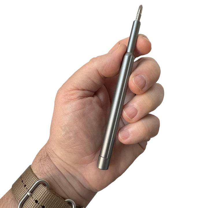 Hand holding a metallic pen on a white background