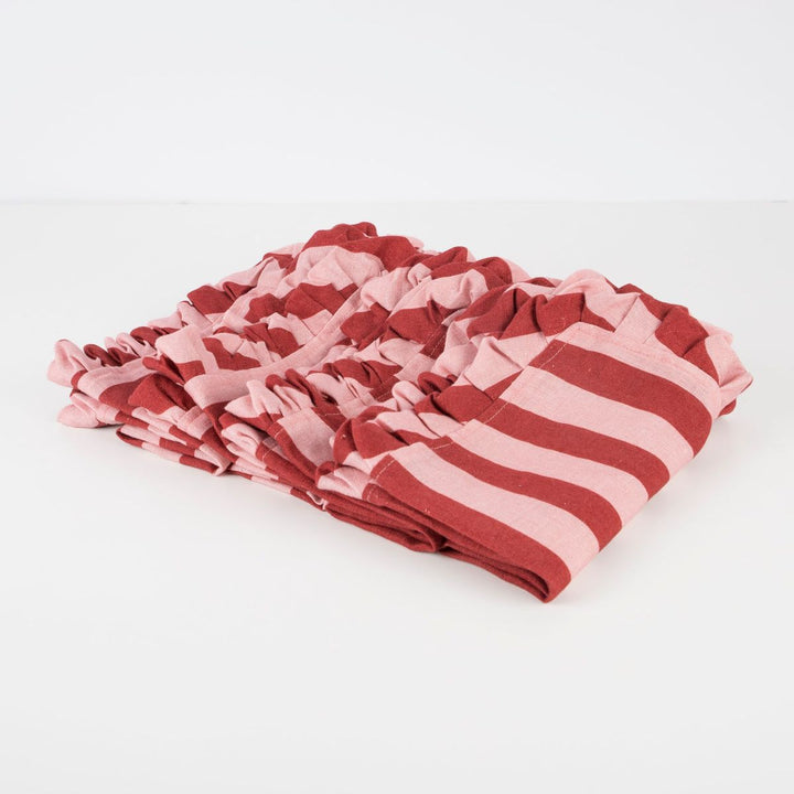 Stack of pink and red striped fabric on a white background
