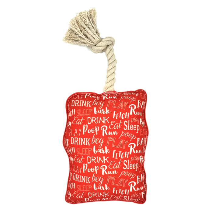 Red dog toy with text pattern and rope on a white background