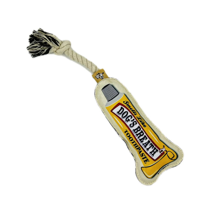 Dog toy shaped like a tube of toothpaste with a rope handle on a white background