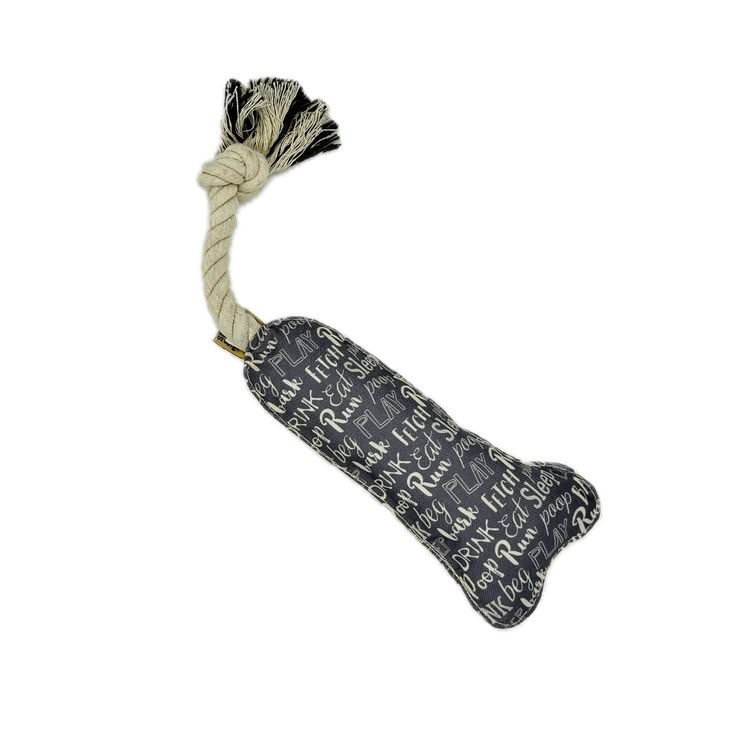 Dog toy with bone shape and rope on a white background