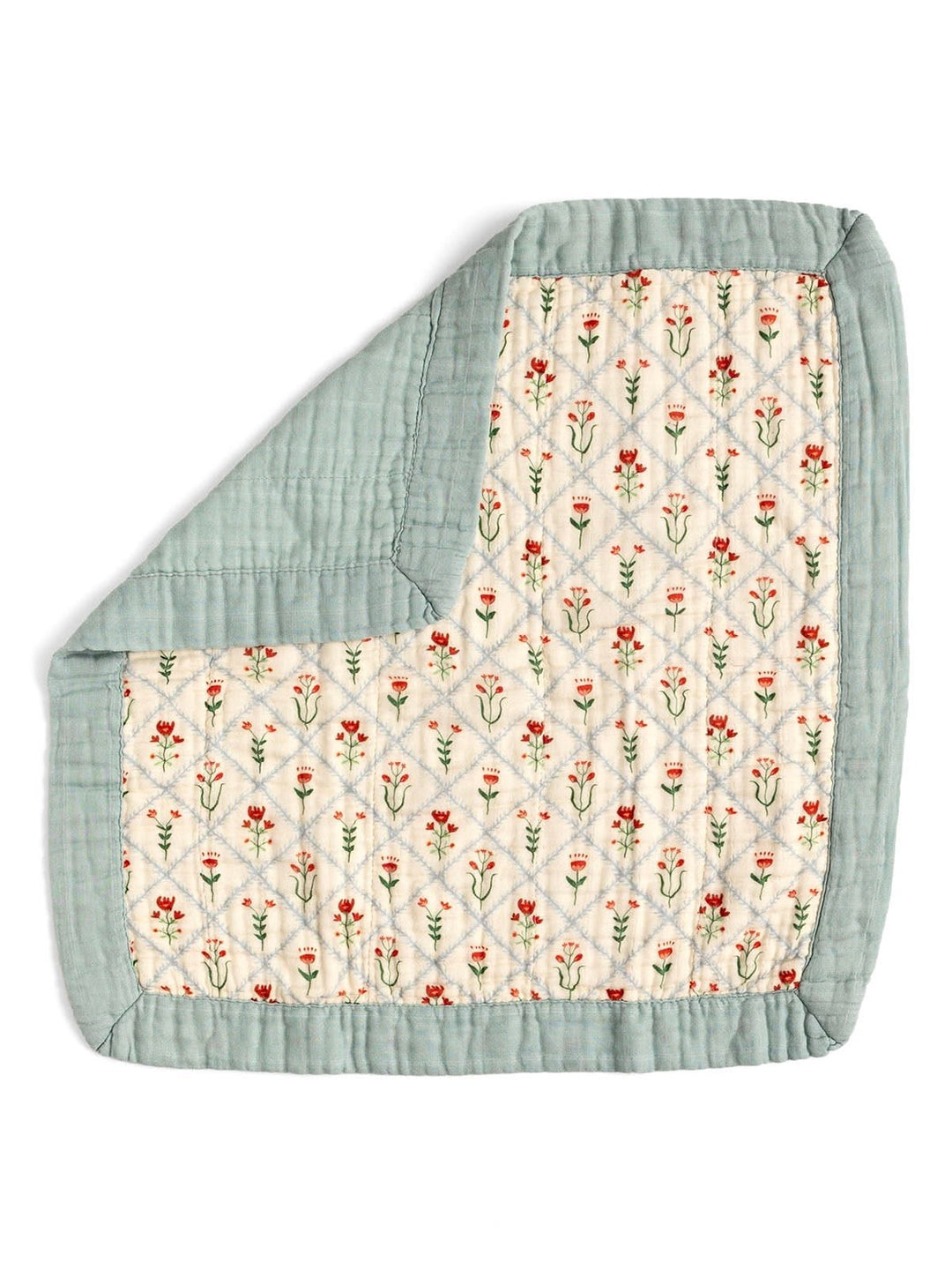 A folded quilted baby blanket with a sage green border and a cream center panel featuring a small red and green floral pattern.