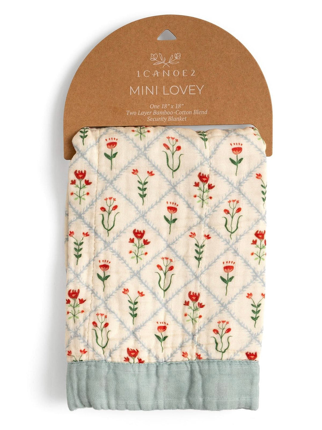 A packaged quilted baby security blanket by CanoeZ, featuring a cream background with a light blue diamond lattice pattern, red and green floral motifs, and a sage green bottom border, attached to a brown cardboard hanger.