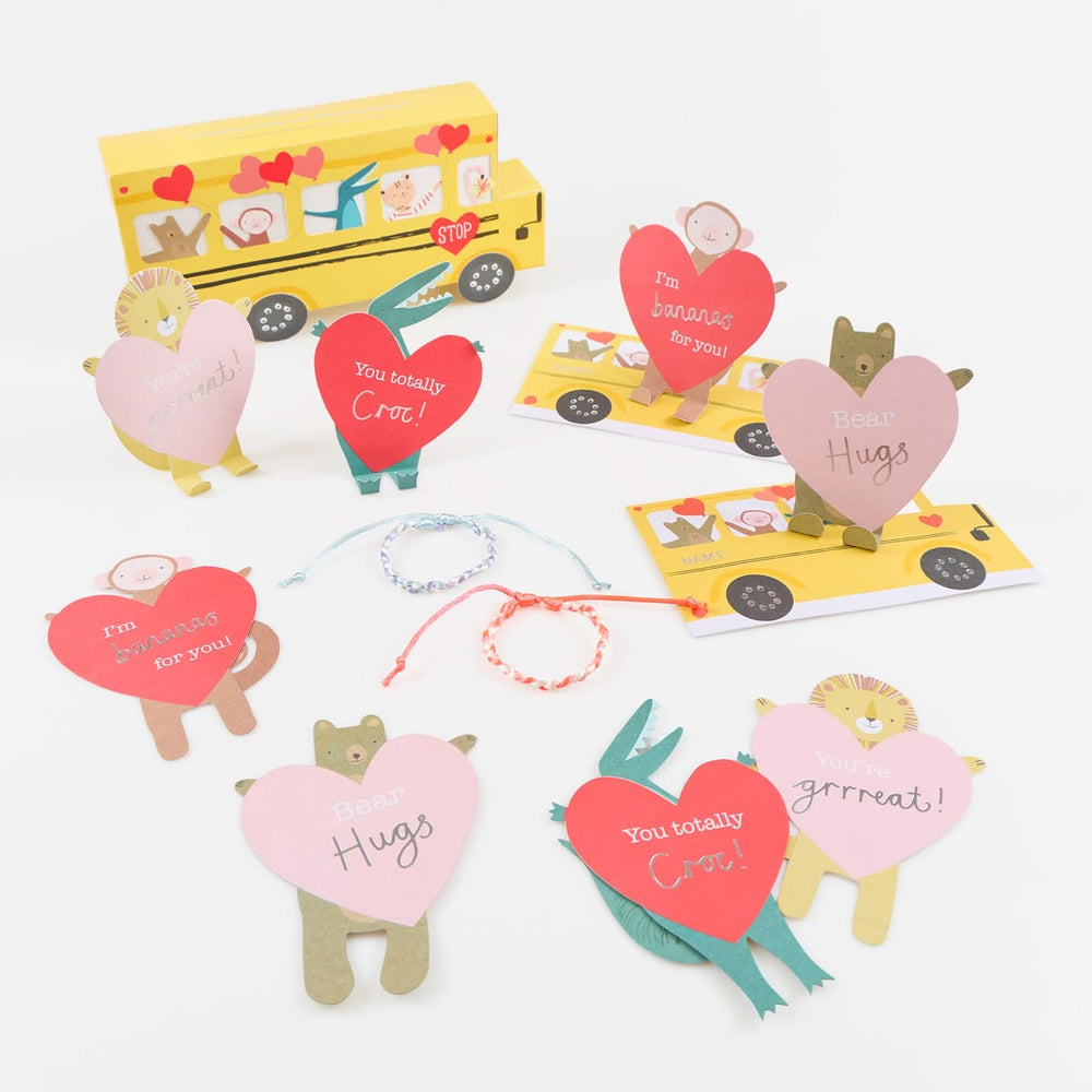 Valentine's Day cards with heart-shaped messages and small figurines on a white background