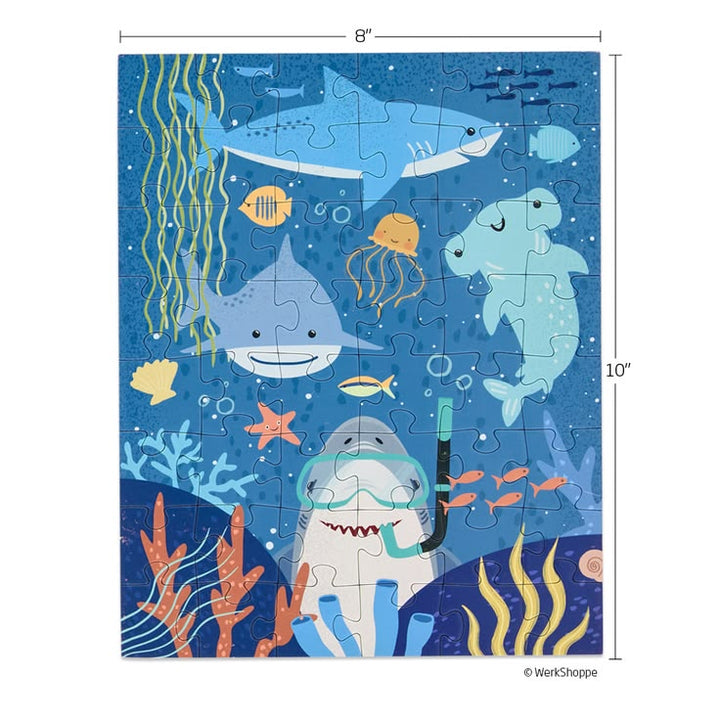 Children's puzzle with shark design and underwater elements, featuring dimensions.