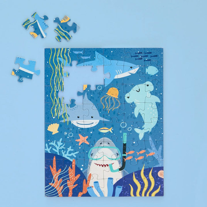 Children's puzzle with shark and ocean theme on a blue background
