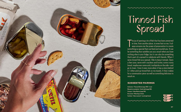 Tins of canned fish with crackers on a table, next to text about tinned fish spread.