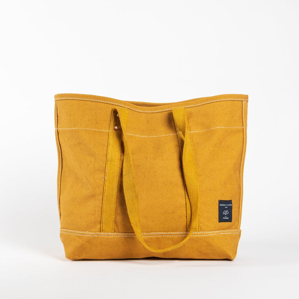 Yellow tote bag with a visible brand label on a white background