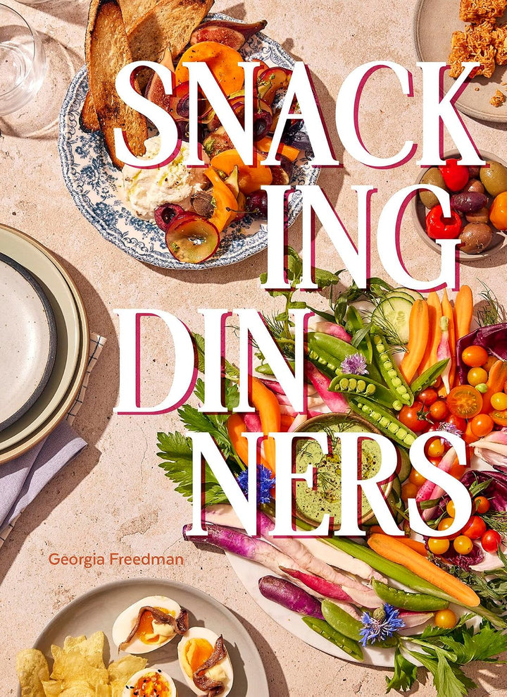 Book cover of 'Snacking Dinners' with plates of food and vegetables on a table.