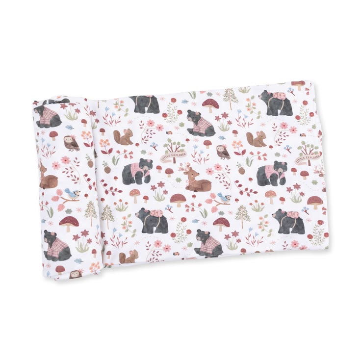 A folded fabric item, likely a blanket or swaddle, featuring a woodland animal print with bears, squirrels, rabbits, mushrooms, and wildflowers on a white background.