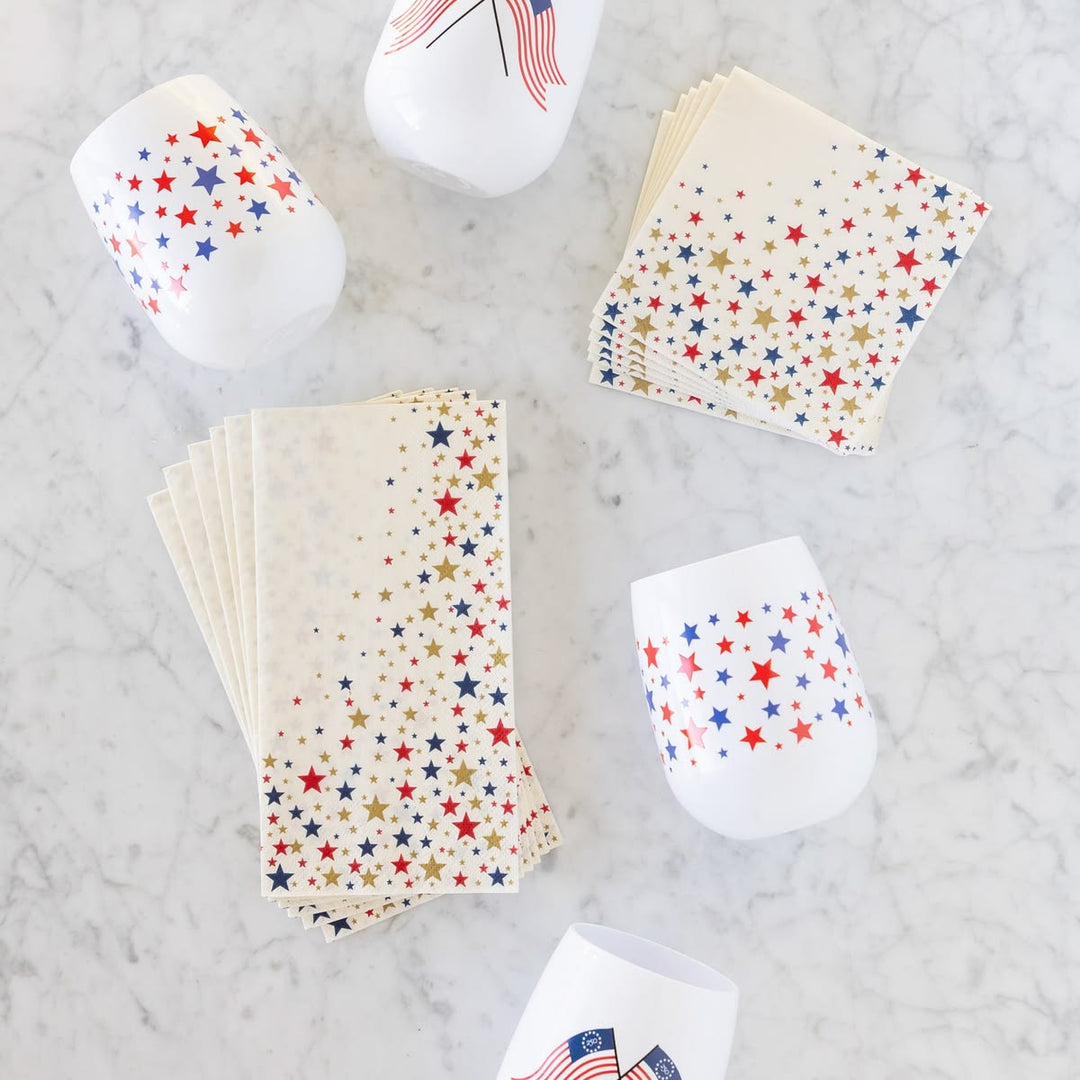Star-patterned paper cups and napkins on a marble surface