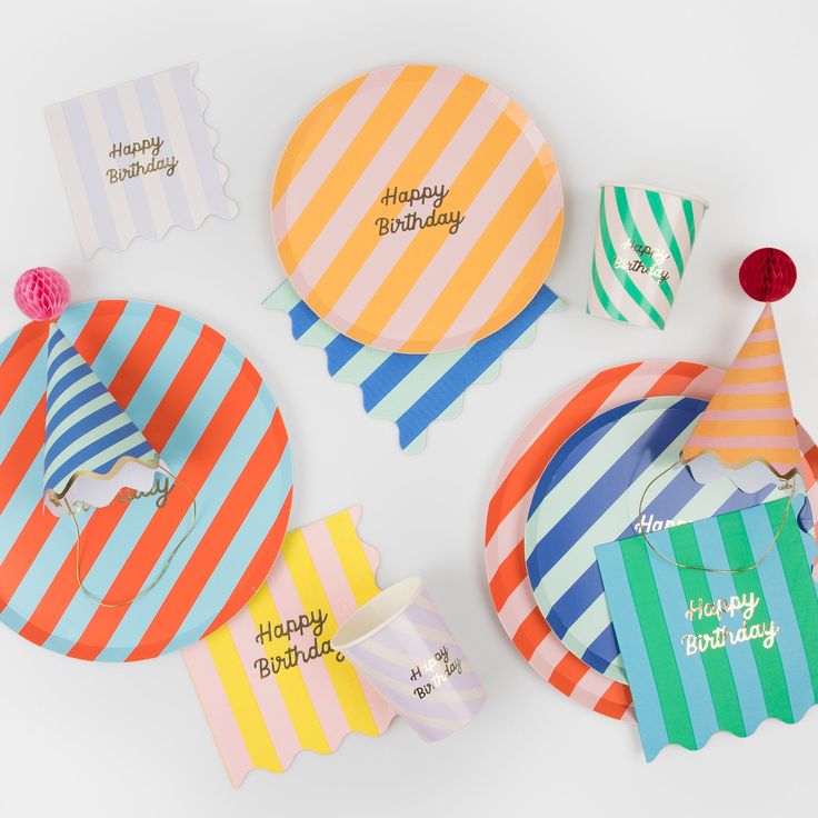 Colorful party hats with 'Happy Birthday' text on a white background