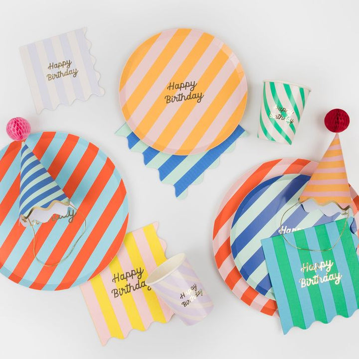 Colorful party hats with 'Happy Birthday' text on a white background
