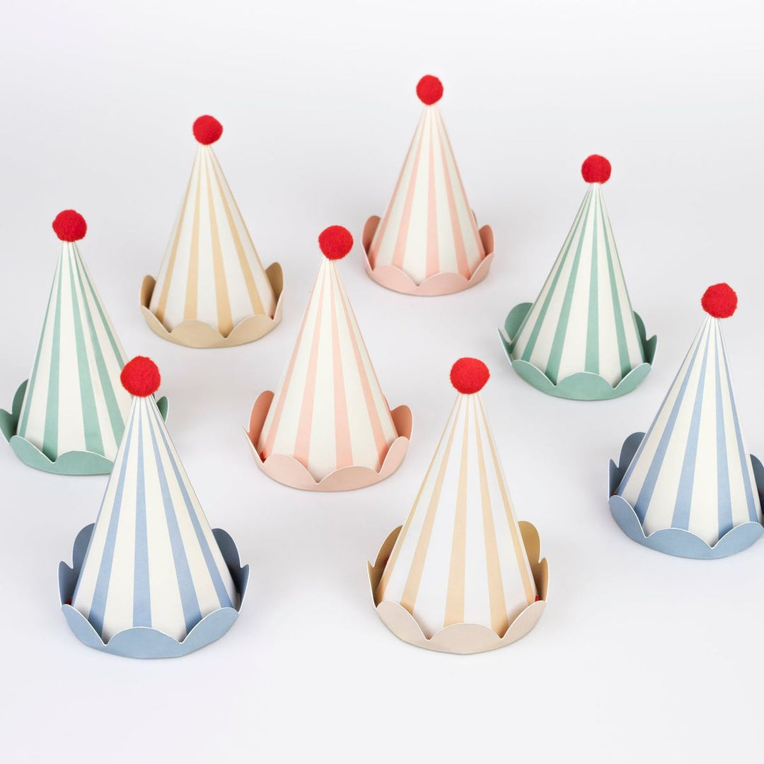 Set of colorful party hats with striped designs on a white background