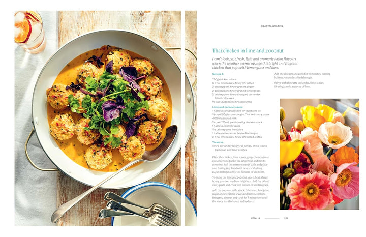 Dish of chicken in lime and coconut with a side of flowers on a magazine page.