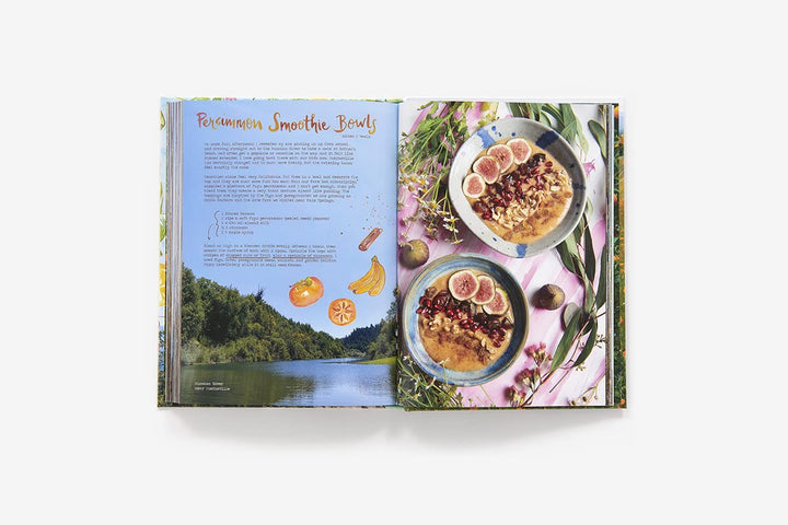 An open printed recipe book or cookbook spread on a light gray background. The left page has a scenic landscape photo and the title 'Peanut Butter Smoothie Bowl' with recipe text.